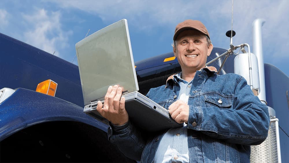 A driver checking assigned loads and updating status from the road.